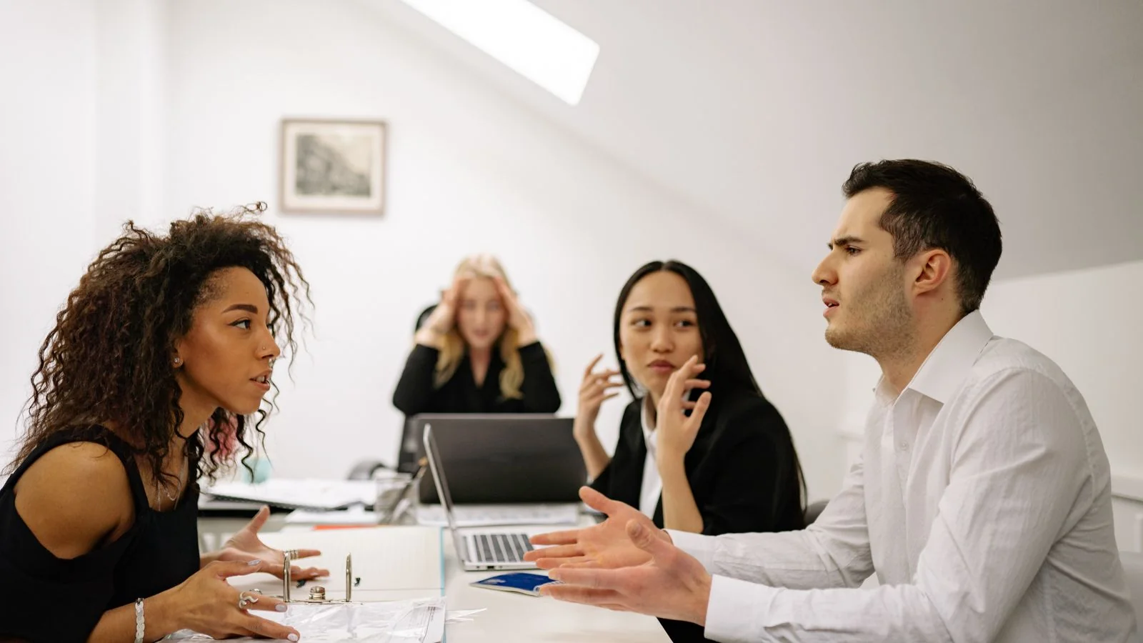 A team collaborating around a table in an office, the everyday credibility that makes employee voices carry weight