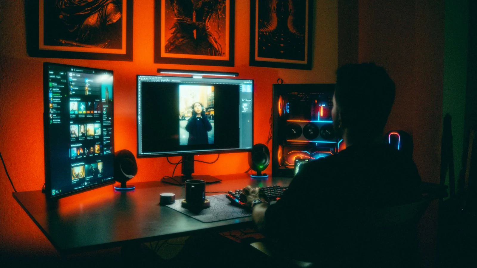 Person editing photos at night on dual monitors in a neon-lit home office