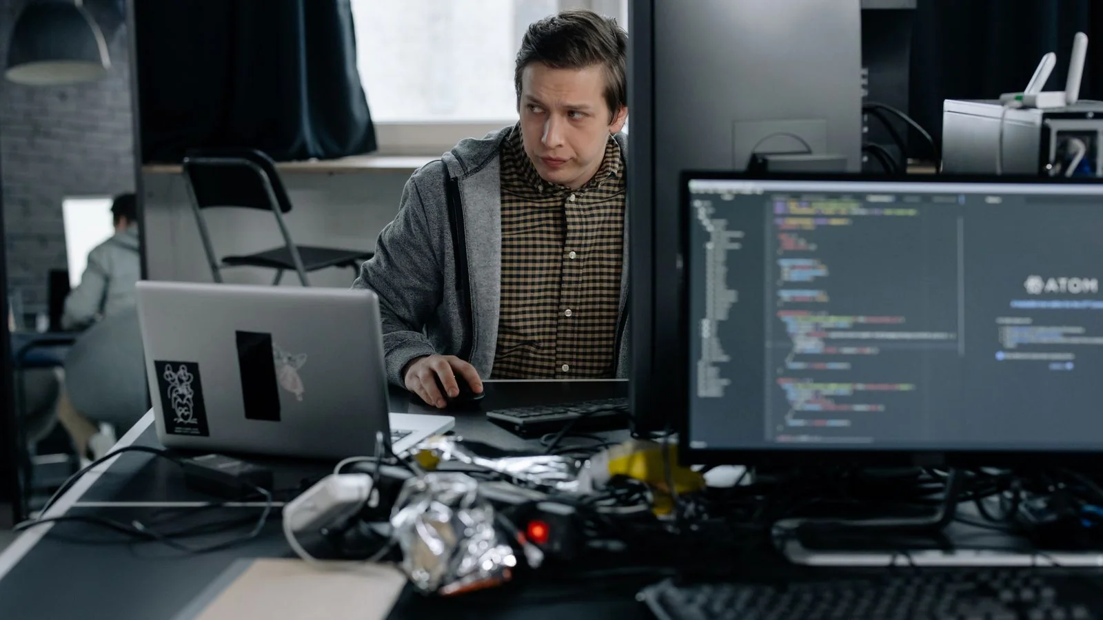 Programmer working with code and structured data on a screen at night