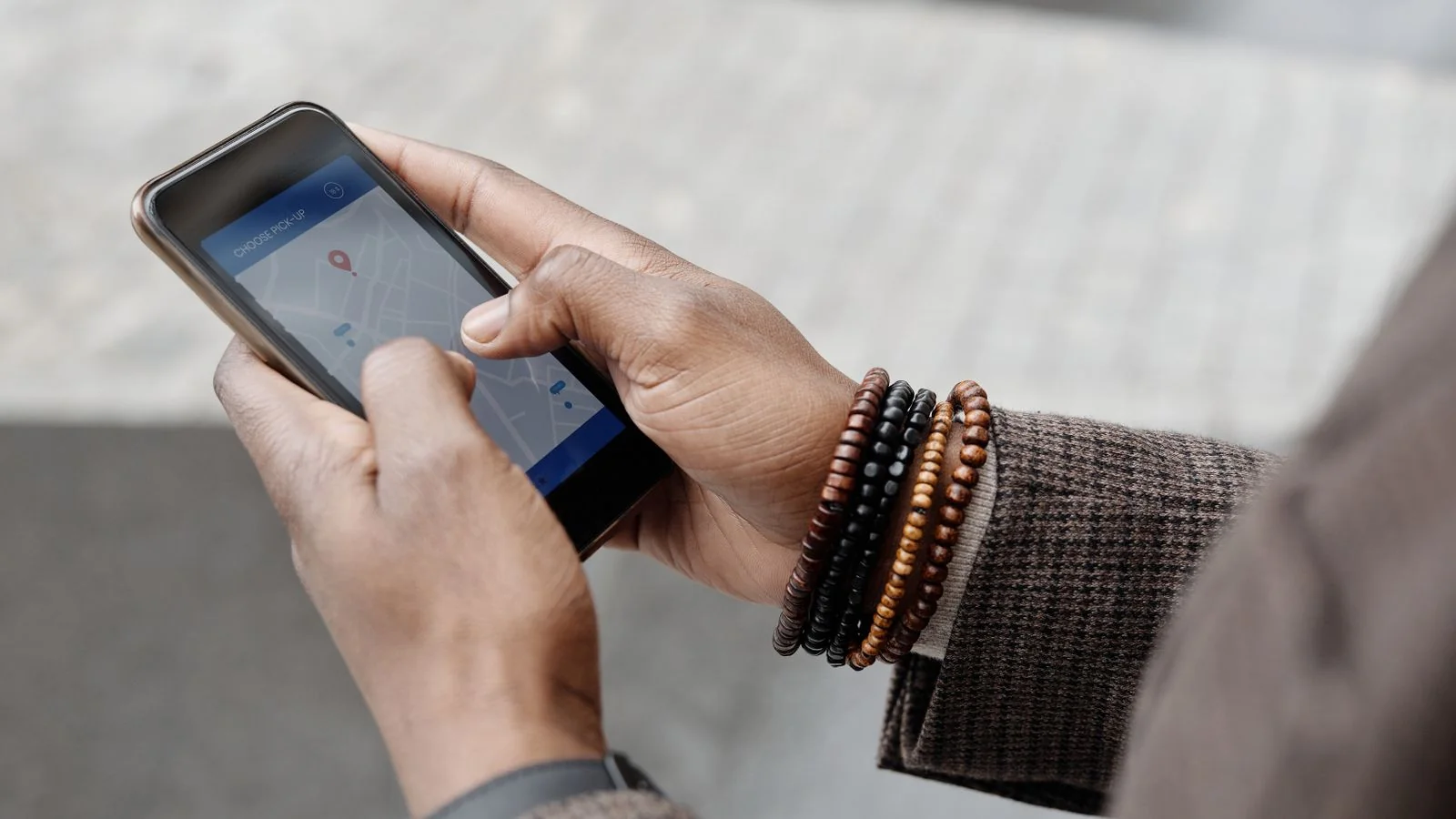 Close-up of hands holding a smartphone with a search app open, the surface where most AI Overview impressions now happen