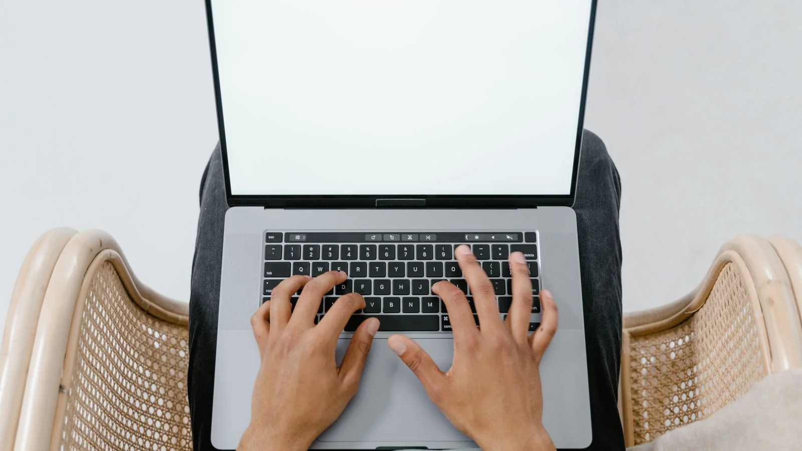 A person using a laptop on their lap, the independent open-web read Claude gives a page on its own merits