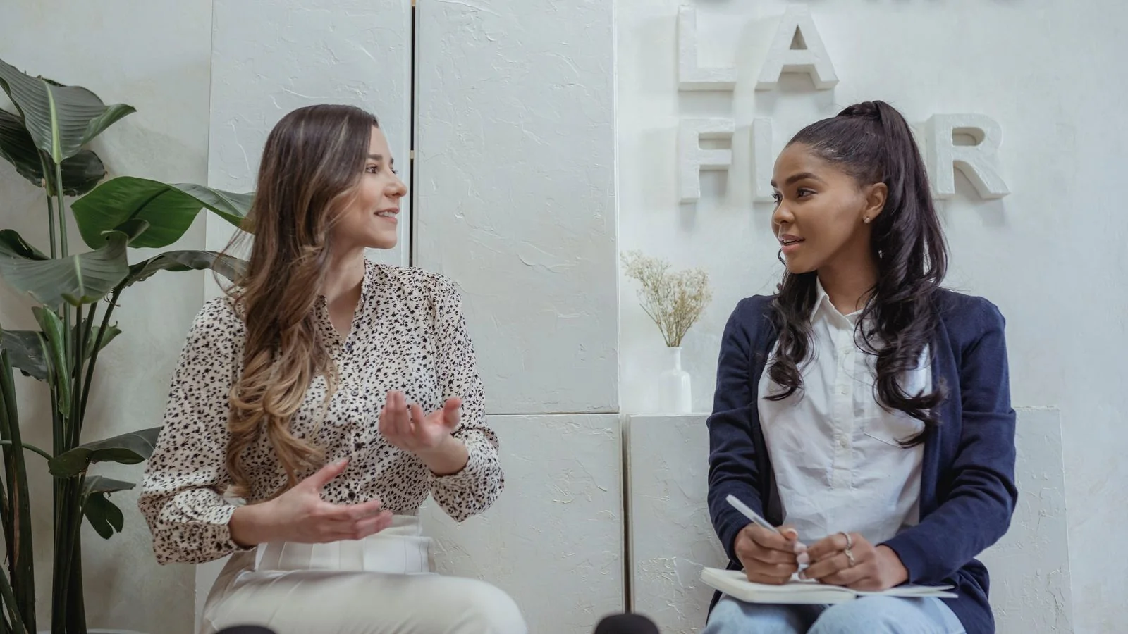 Two people in conversation during a recorded interview, the format that produces named coverage