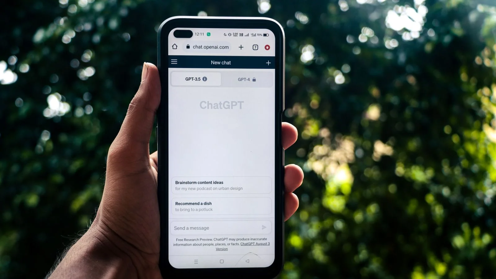 Someone using an AI assistant on a phone outdoors, increasingly where the first search about you happens