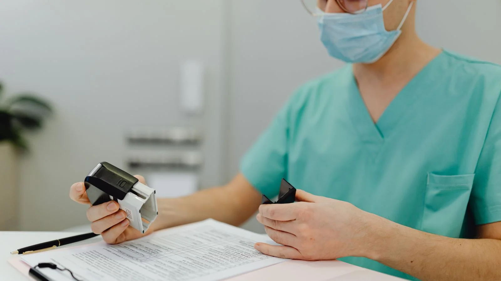 A healthcare worker in scrubs reviewing patient files, the records discipline that entity data demands