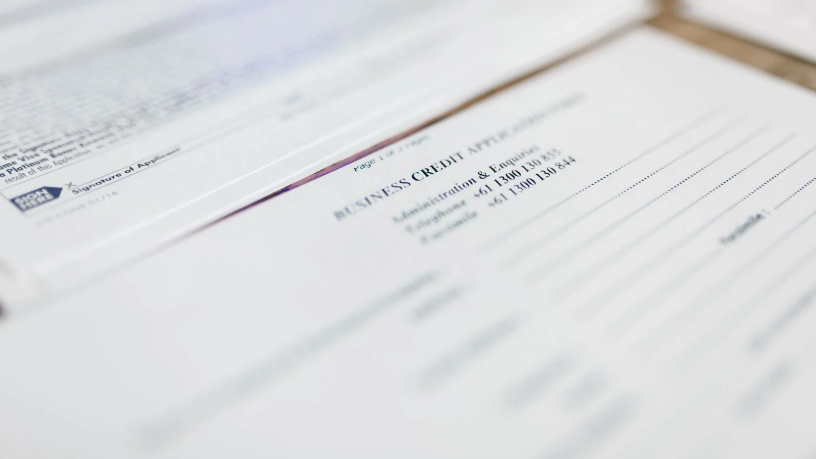 Business credit application and finance paperwork laid out on a desk