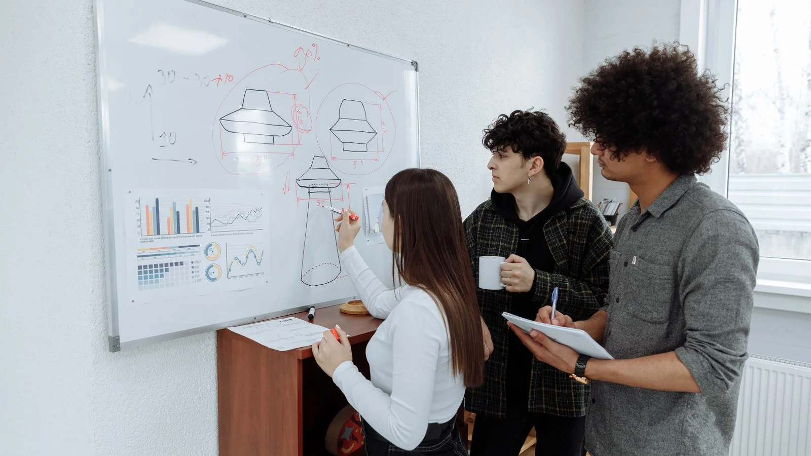 Whiteboard covered in product sketches, the work that happens long before anyone else describes it