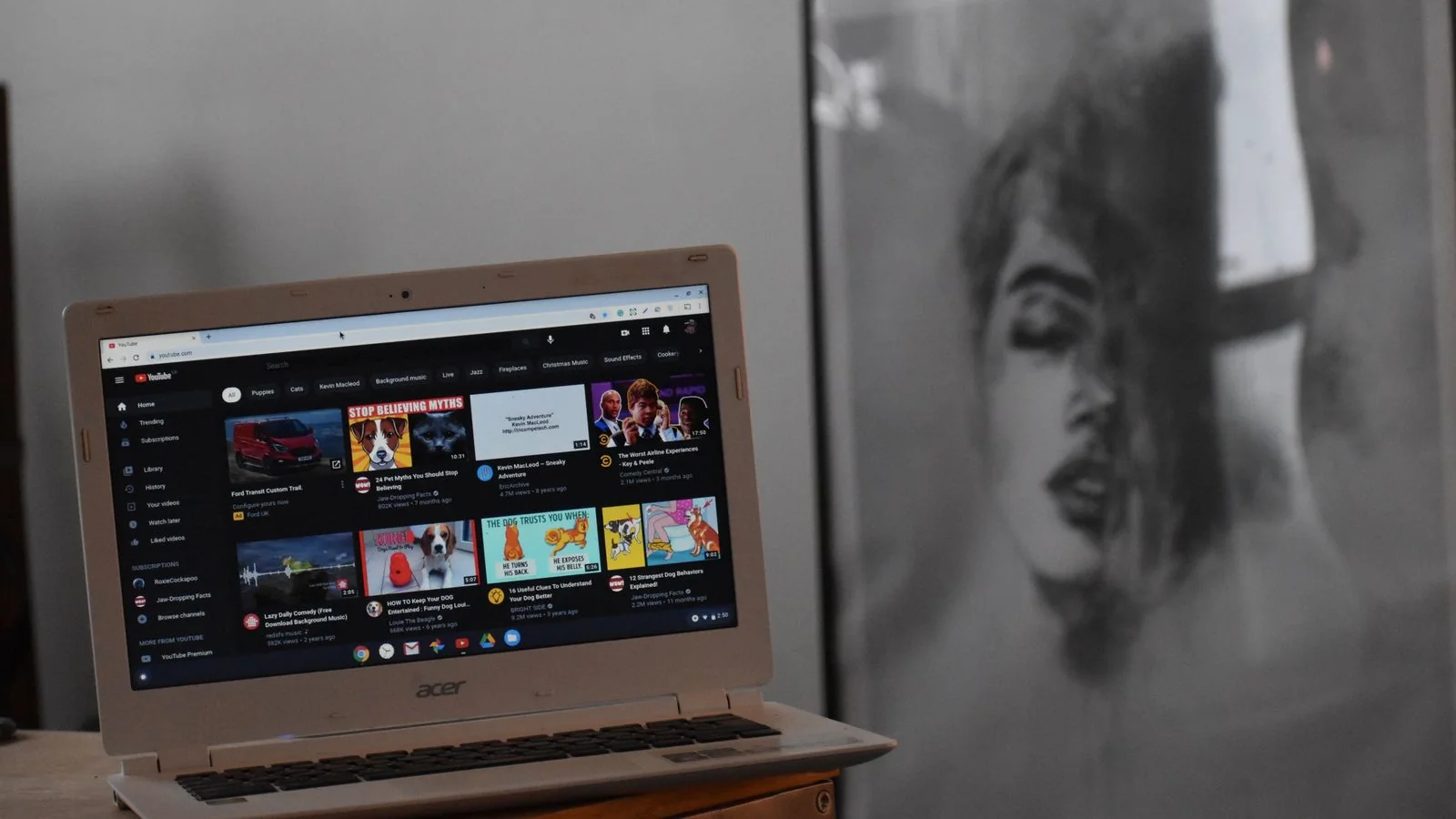 Laptop on a wooden table displaying YouTube, the channel entity Google tracks separately from its creator