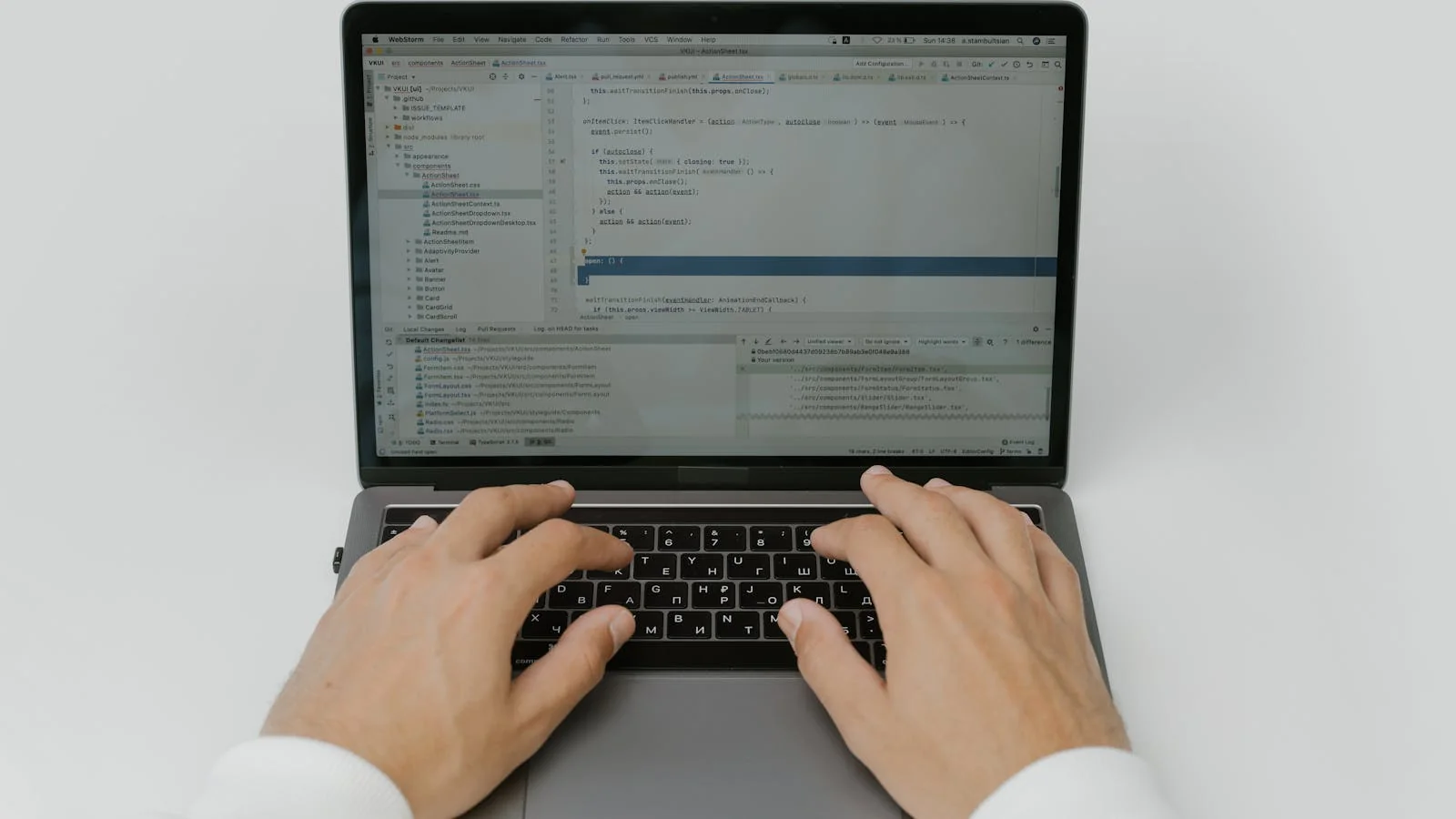 Hands on a laptop in a low-lit room, the workflow of the practitioner doing the ranking-signal work