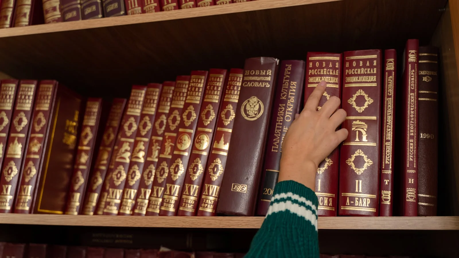 Open hardcover encyclopedias on a library shelf with multicolored spines, the kind of structured reference source AI models prefer.