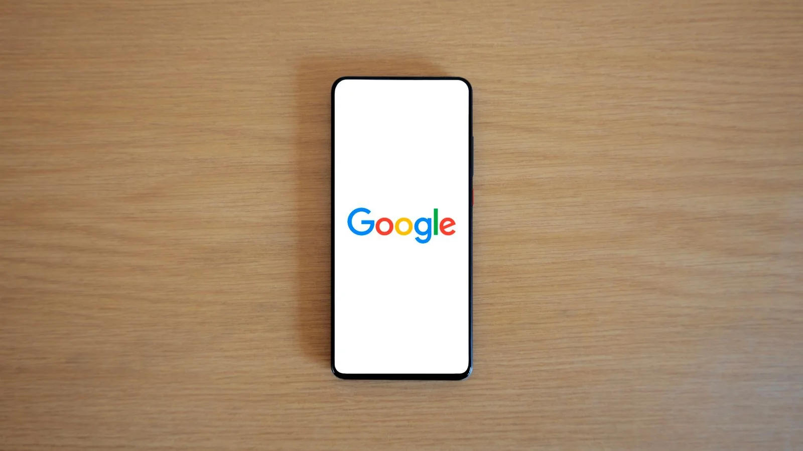A smartphone showing the Google homepage, the live search step that decides which pages SearchGPT even considers