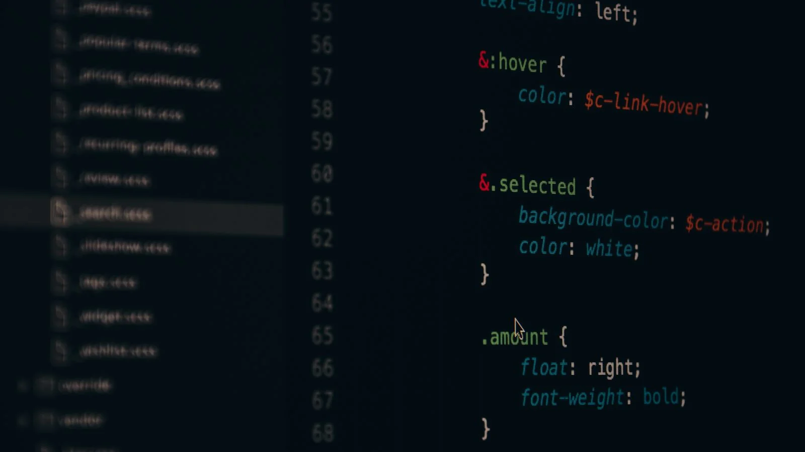 Web developer building out a structured site page on a laptop