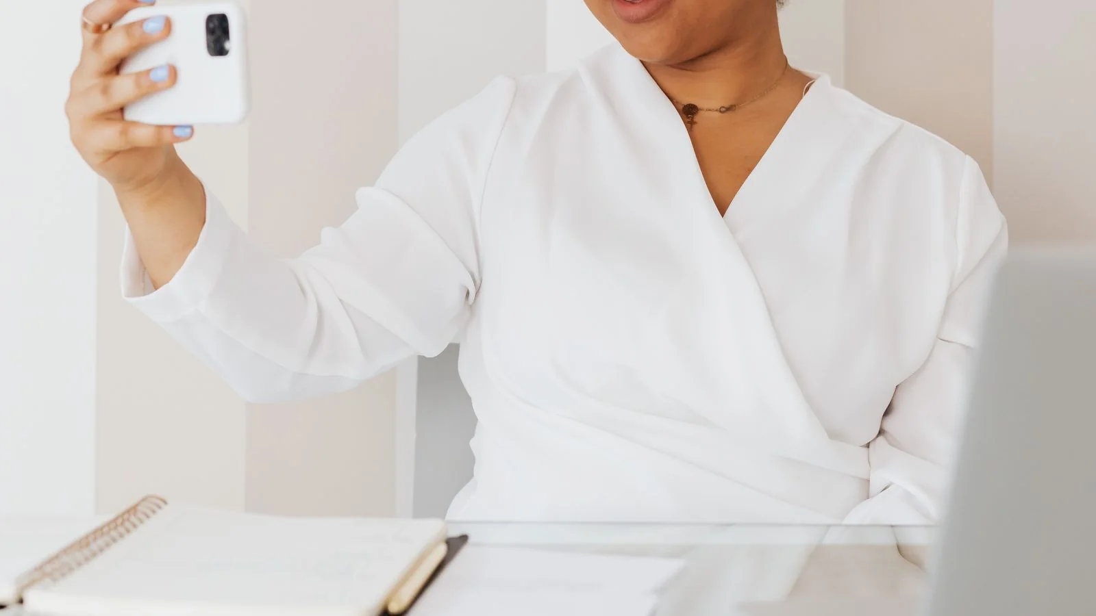 A person working on a laptop in a focused setting, building presence on one platform at a time