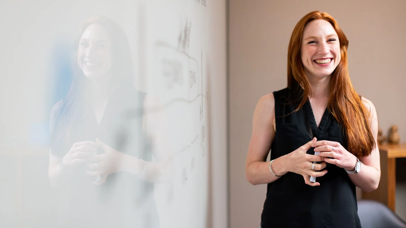 Businesswoman speaking during a corporate presentation while colleagues watch, one artifact in a longer body of work