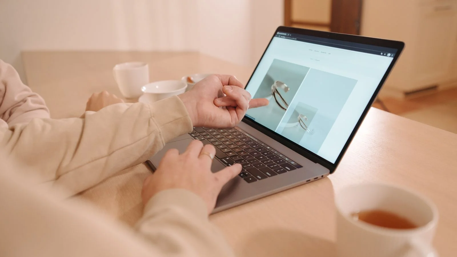 Two people reviewing a search results page together on a laptop
