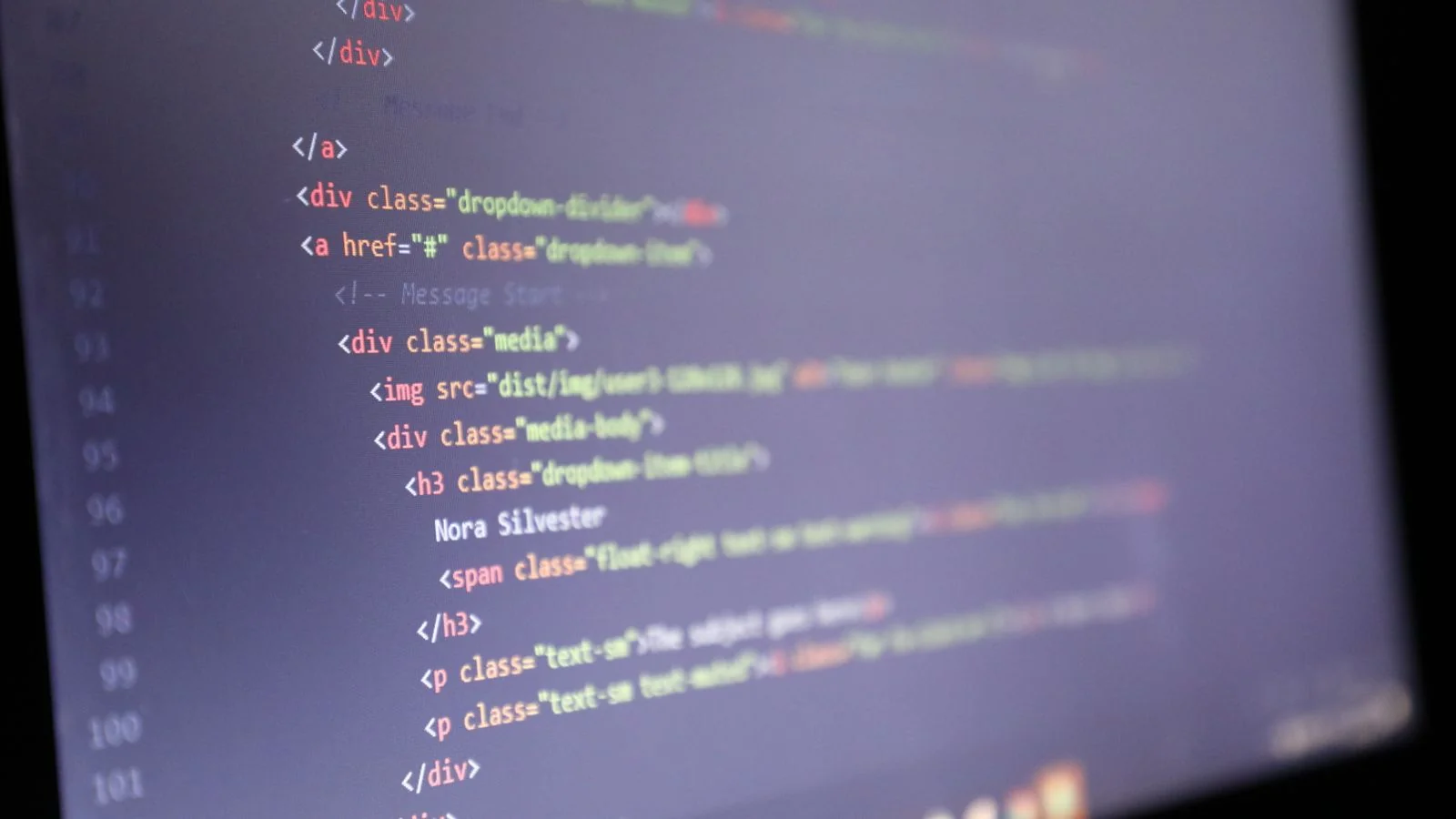 Lines of illuminated code glowing on a dark computer screen