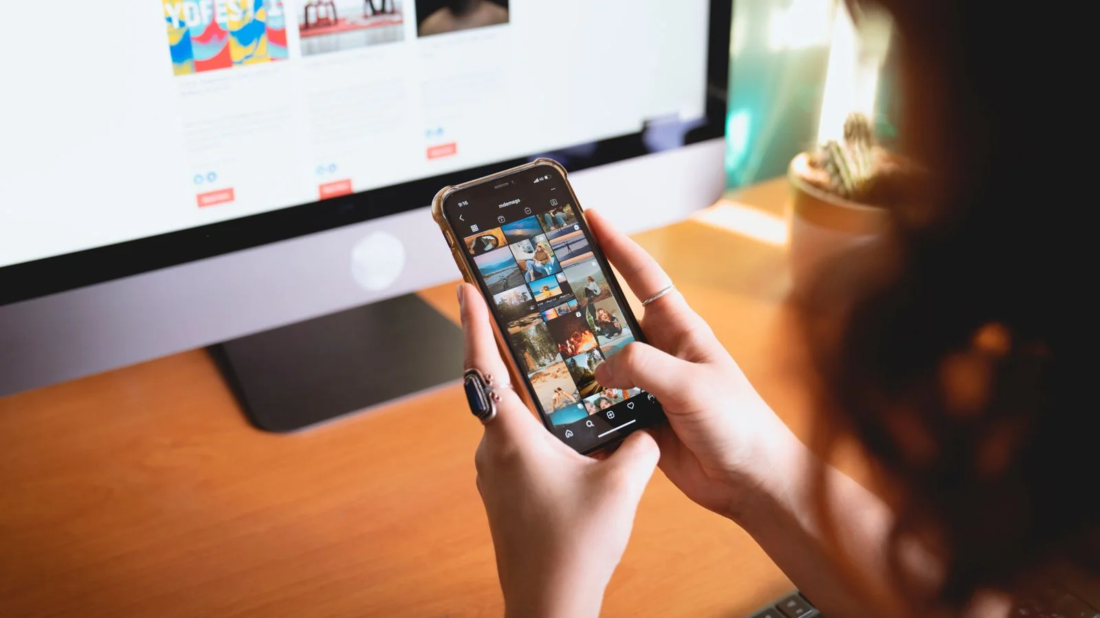 Hands holding a phone scrolling a social feed, auditing what a stranger would actually find