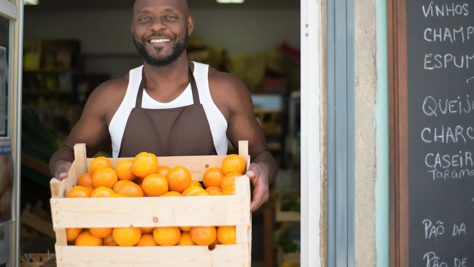 A shop owner at the counter of a local store, the kind of business a verified Google listing brings customers to
