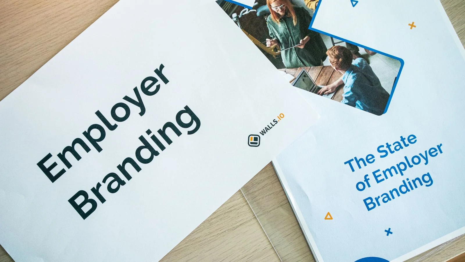 Flat lay of branded marketing materials and signage laid out on an office table