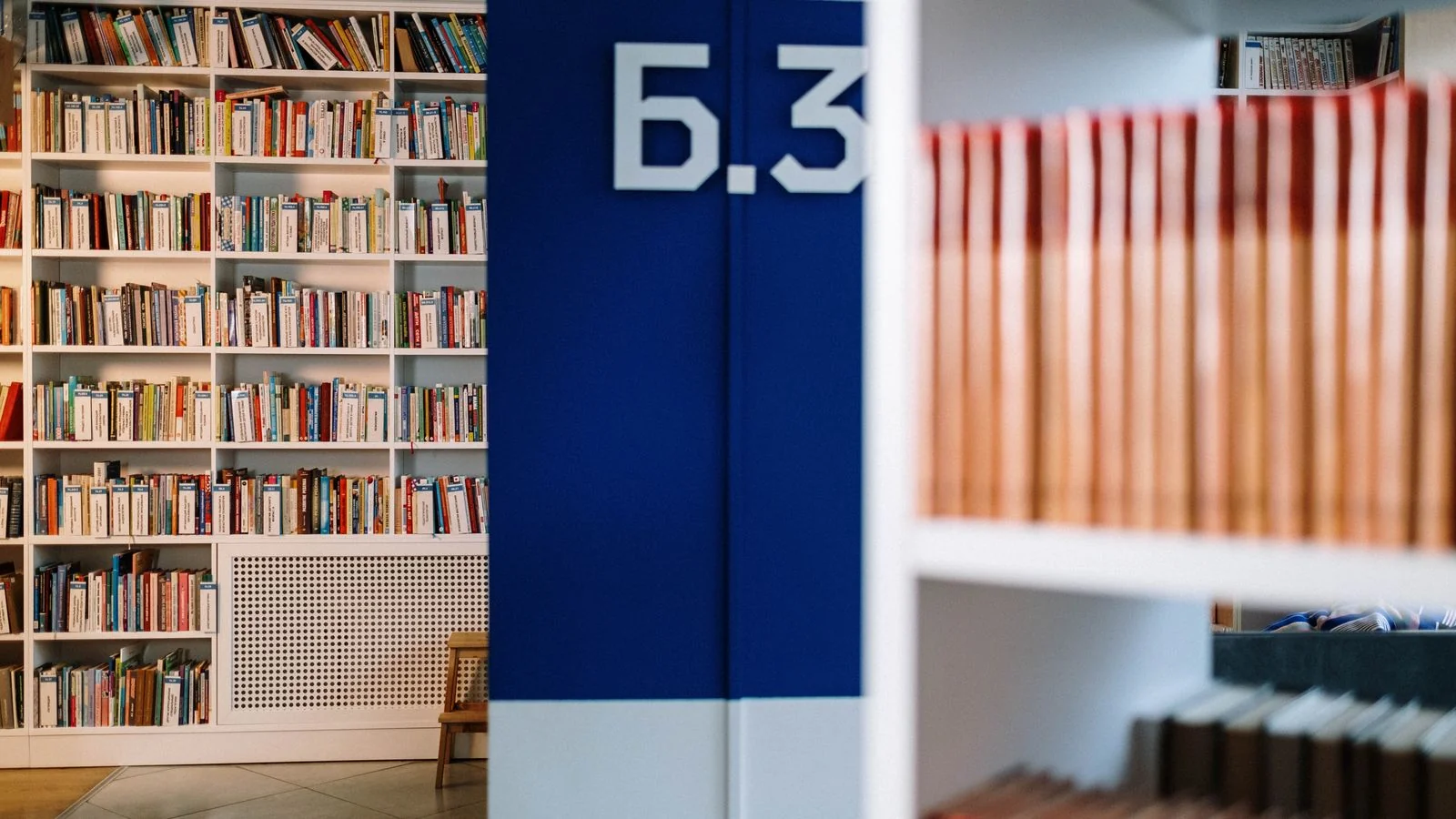 Cozy modern library interior with aisle signage, the organized context a resource page adds around each link
