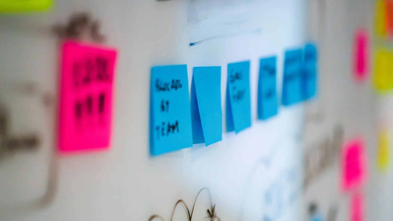 Sticky notes on a whiteboard during a brainstorming session, the raw material the calendar needs