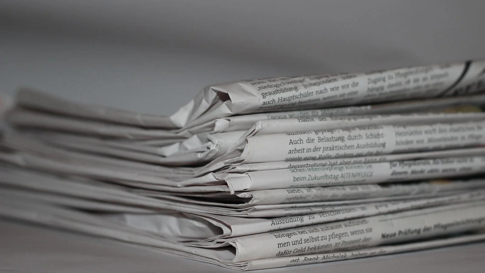 Stack of newspapers representing media coverage and authoritative press for reputation management