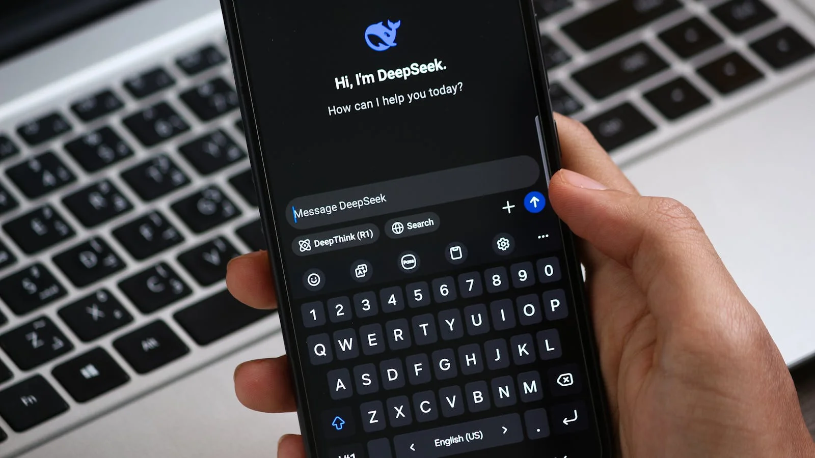 A person holding a phone with an AI chat open, the structured presence that lets a model place you.