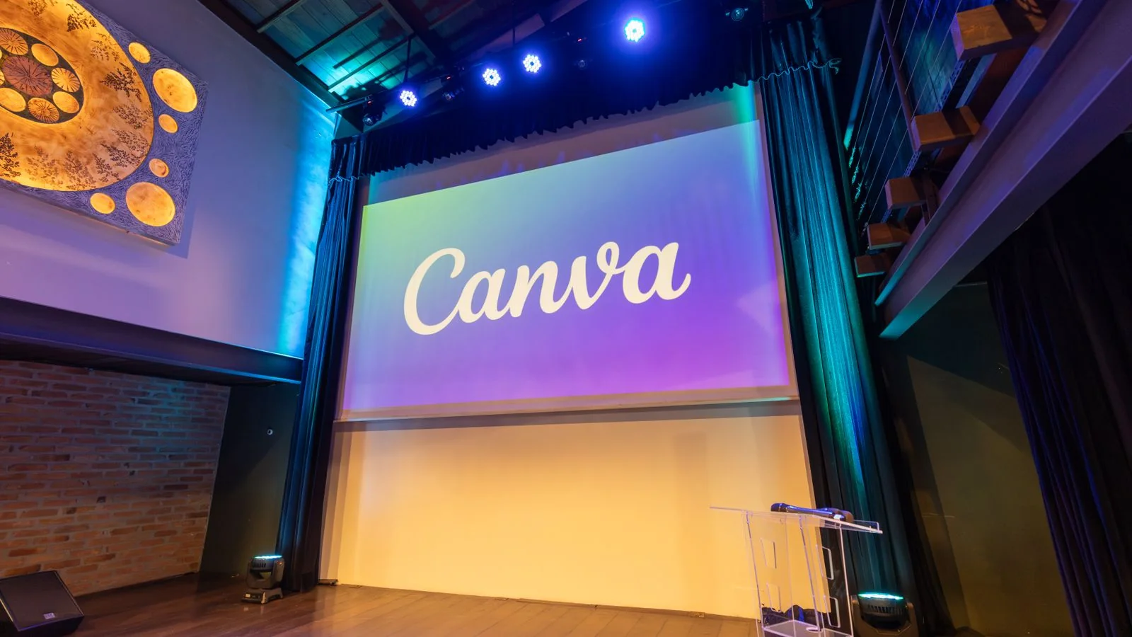 An empty conference stage with a wide screen, the venue where startup news usually gets made