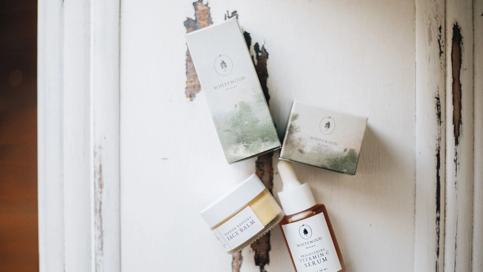 Minimalist luxury skincare products arranged on a clean editorial surface for brand photography