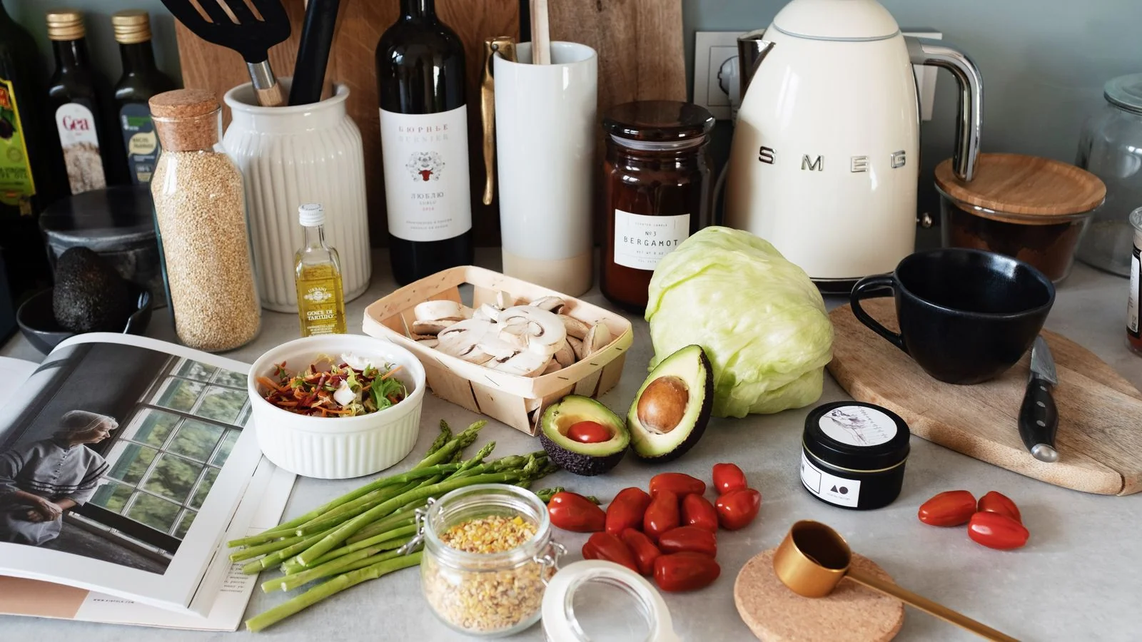 A flat lay of fresh cooking ingredients and utensils on a gray kitchen countertop