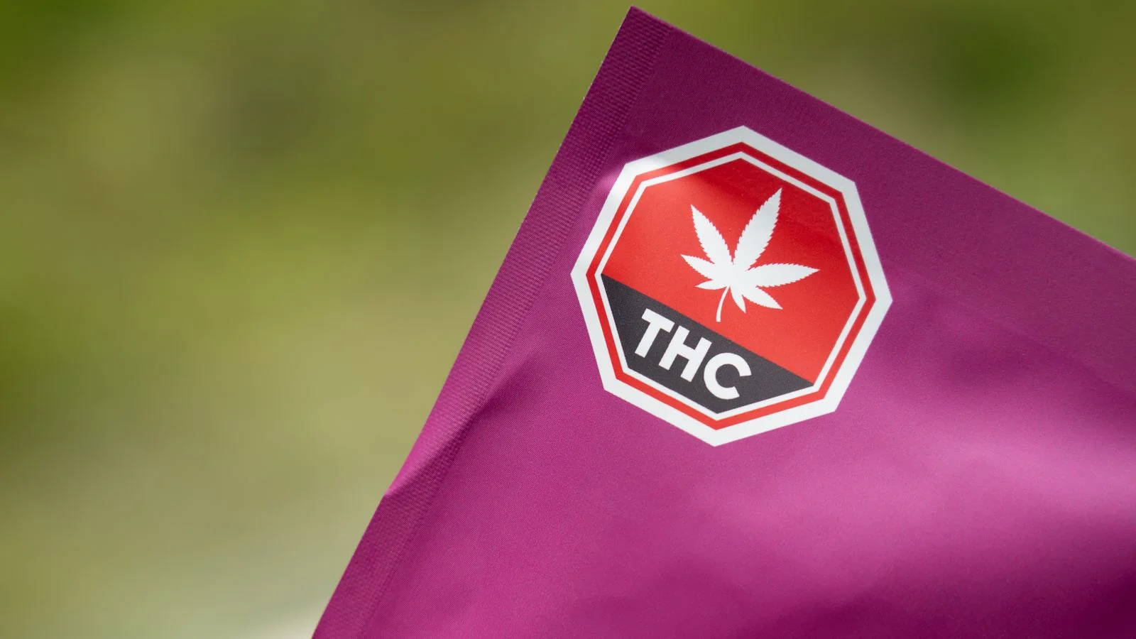 Cannabis product packaging displays a THC warning label, signaling regulatory compliance