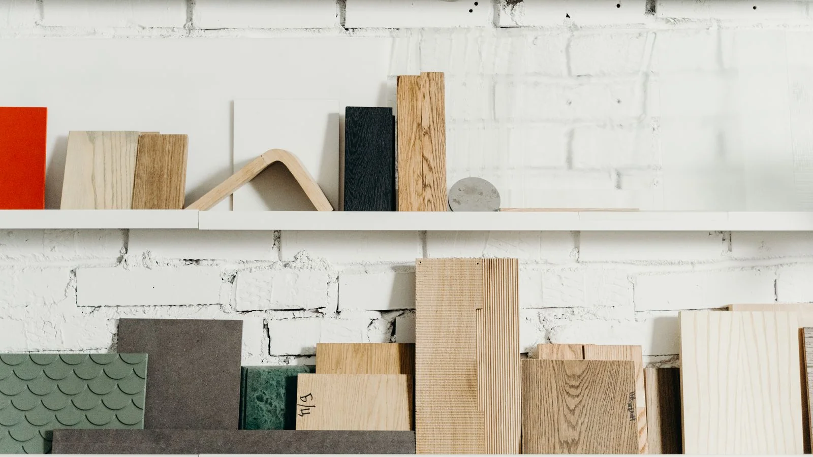 Shelves of wooden planks and material samples in a workshop, the specifics Dwell editors ask you to name