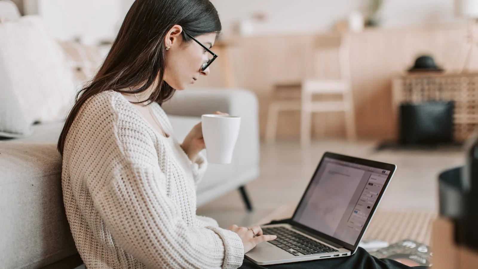Freelance contributor drafting a pitch on her laptop at home, the actual sender behind most accepted features