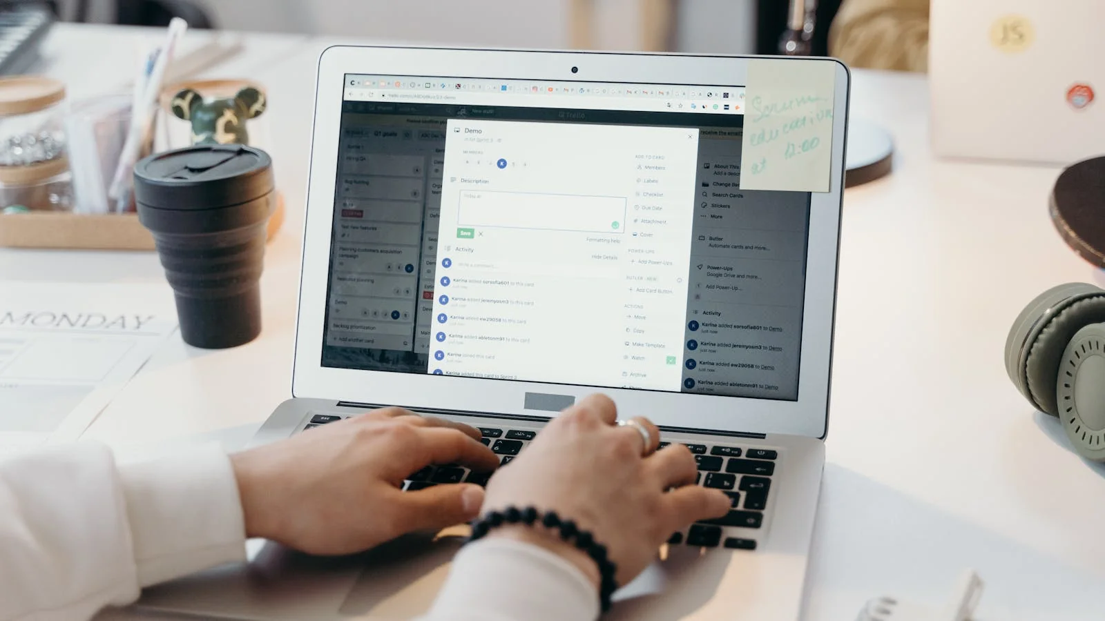 A person typing at a laptop in a bright office, drafting a pitch email