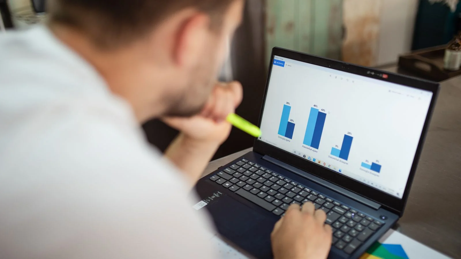An analyst reviewing charts on a laptop, the kind of verifiable track record finance editors look for