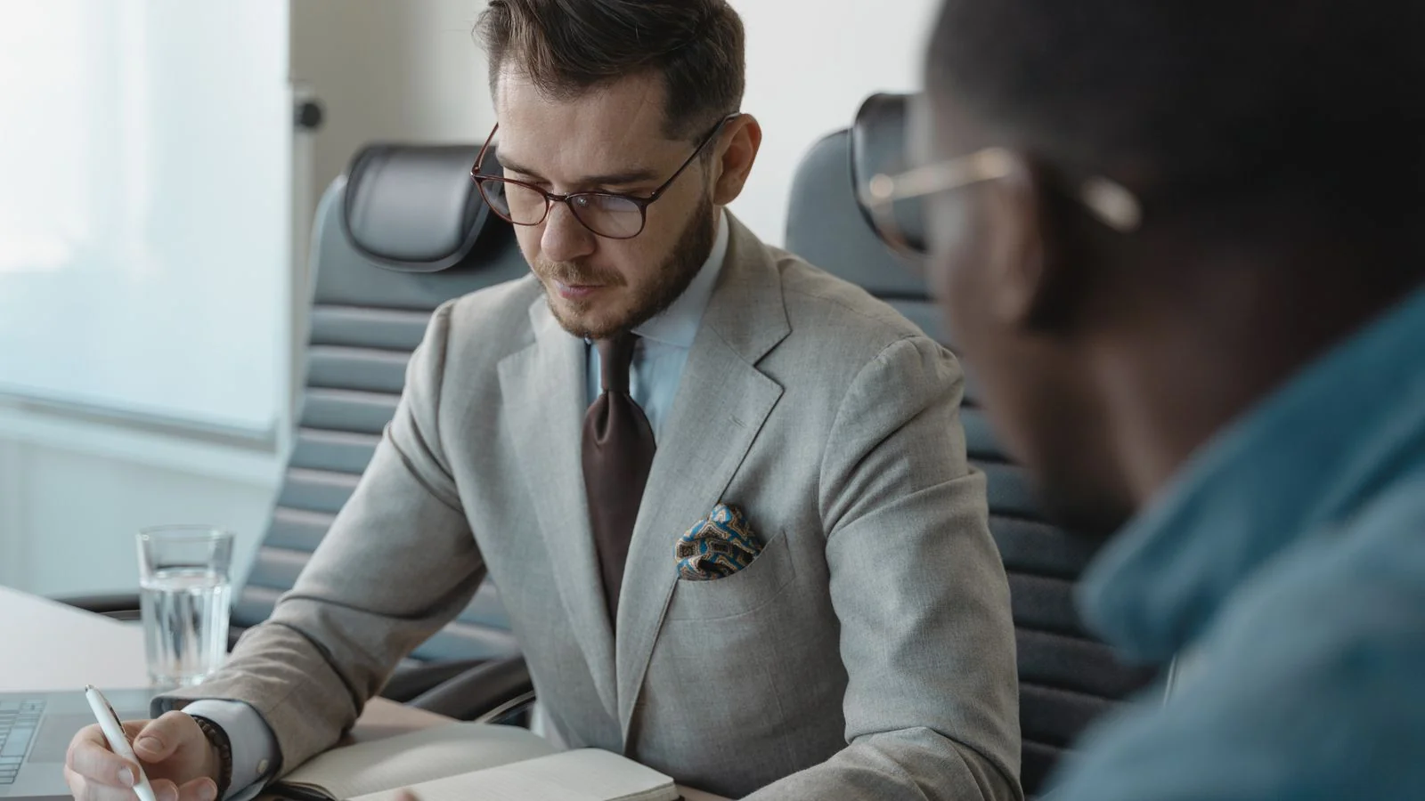 Two professionals in focused discussion during a business interview