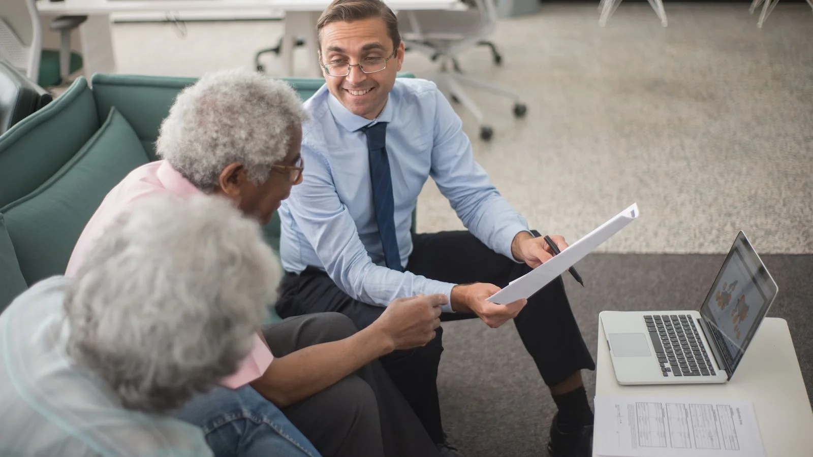 Financial adviser going through documents with clients at a table