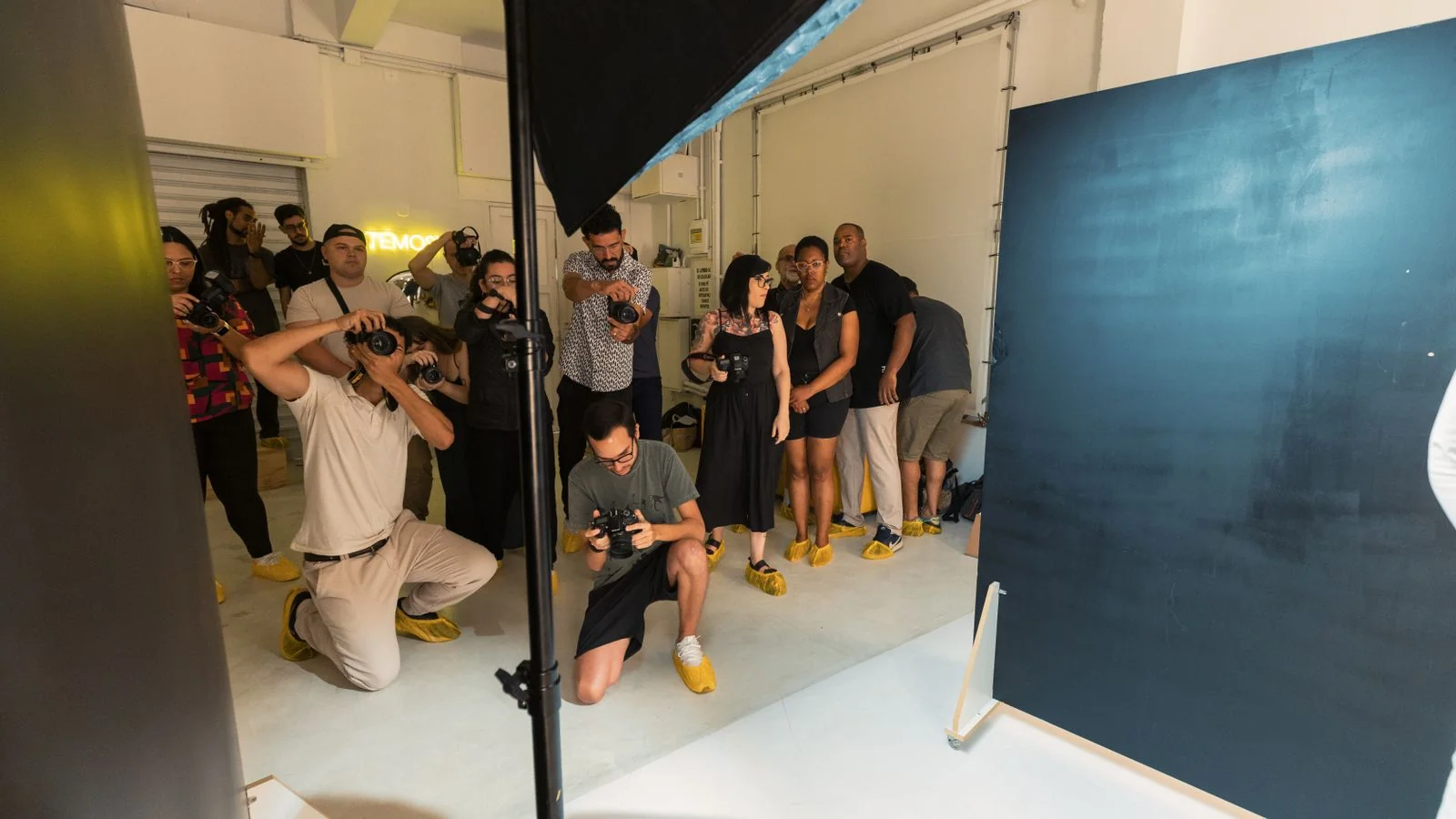 Photographers at work during a group photography session in a studio