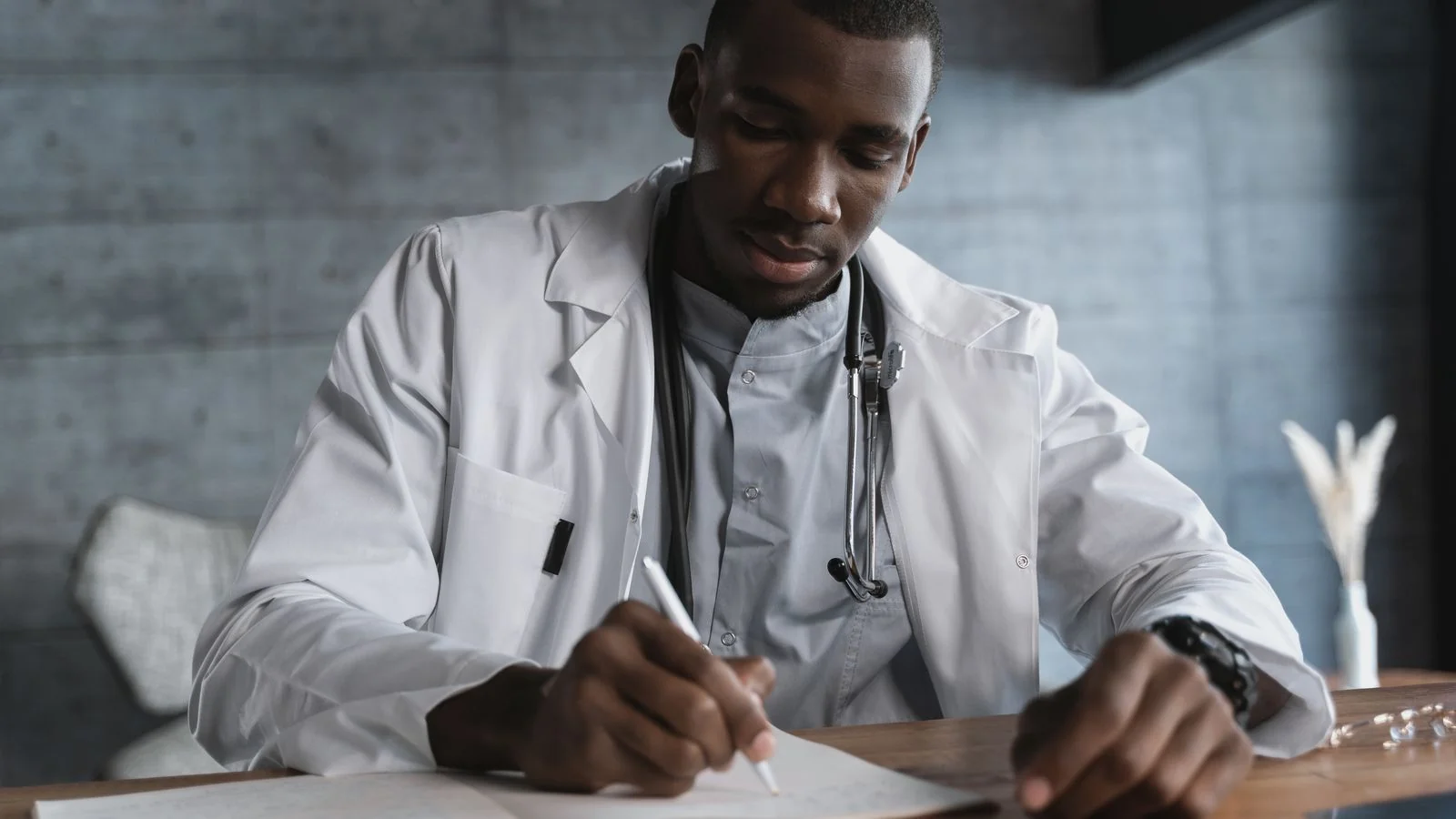 A doctor writing notes at a desk, the kind of source health editors trust when the evidence is specific