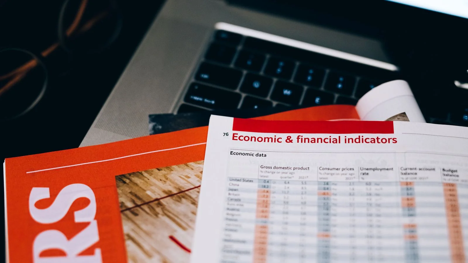 Financial documents and charts beside a laptop keyboard, the raw material of a data pitch
