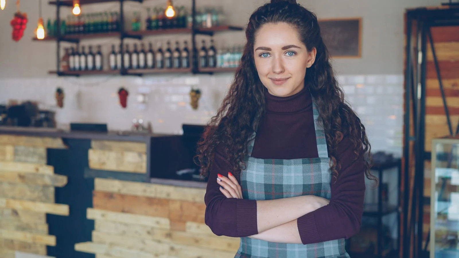 A confident cafe owner standing inside a cozy coffee shop, the small-business operator profile that the Chronicle's local-features writers chase every week.