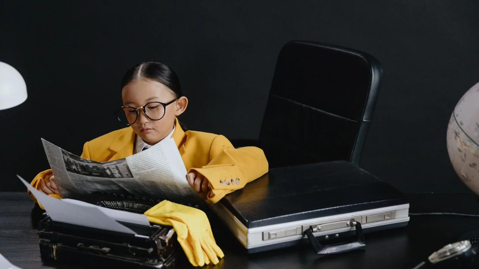 Person reading a newspaper at a desk, the reader an original-data story is built to reach