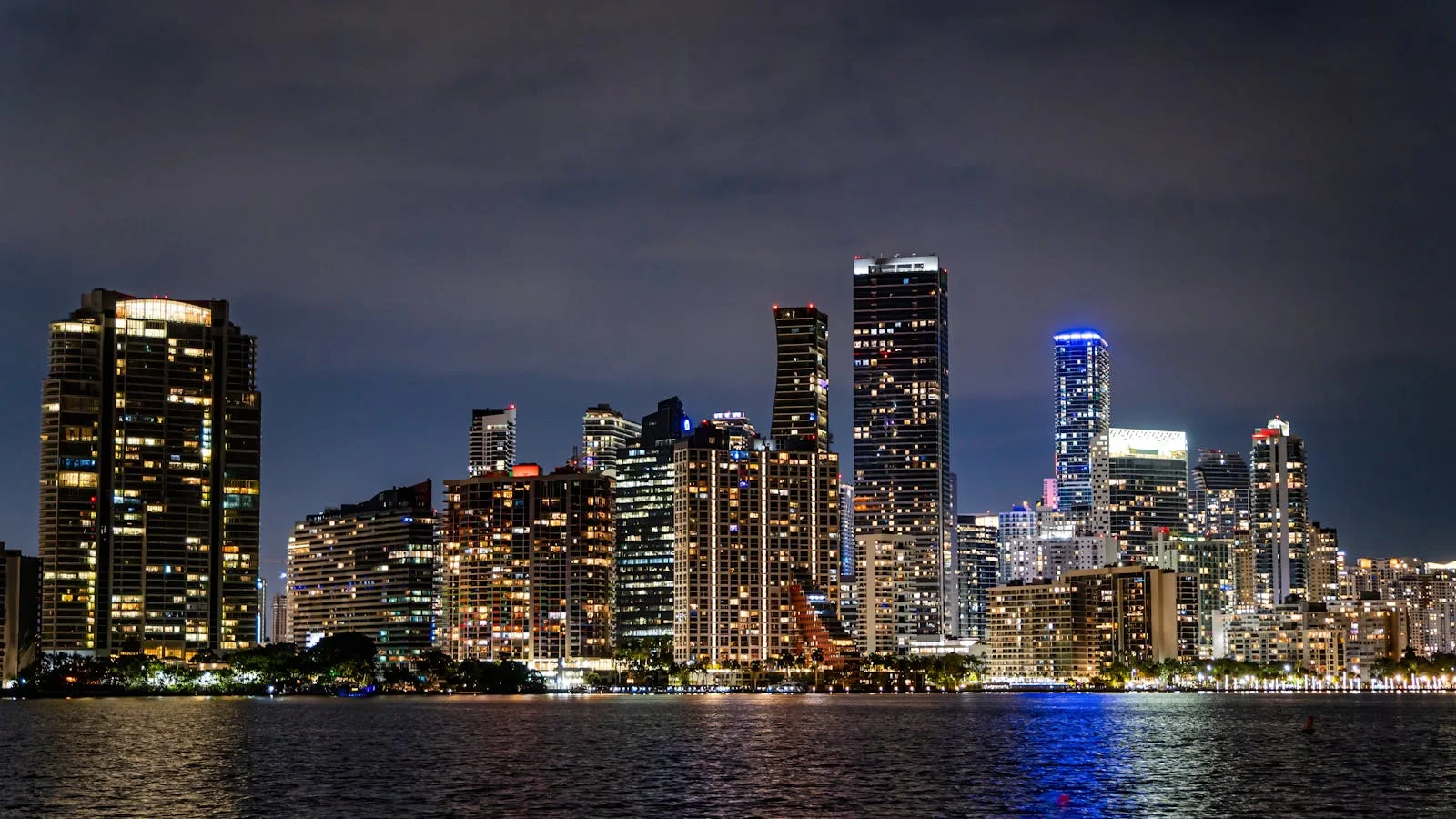 The Miami skyline lit up at night, the seasonal backdrop a Herald reporter writes against