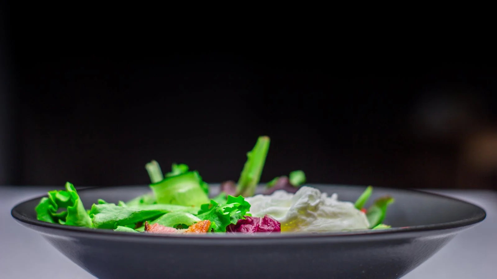 Vibrant green salad in a bowl representing the kind of nutrition content MBG editors look for from credentialed contributors