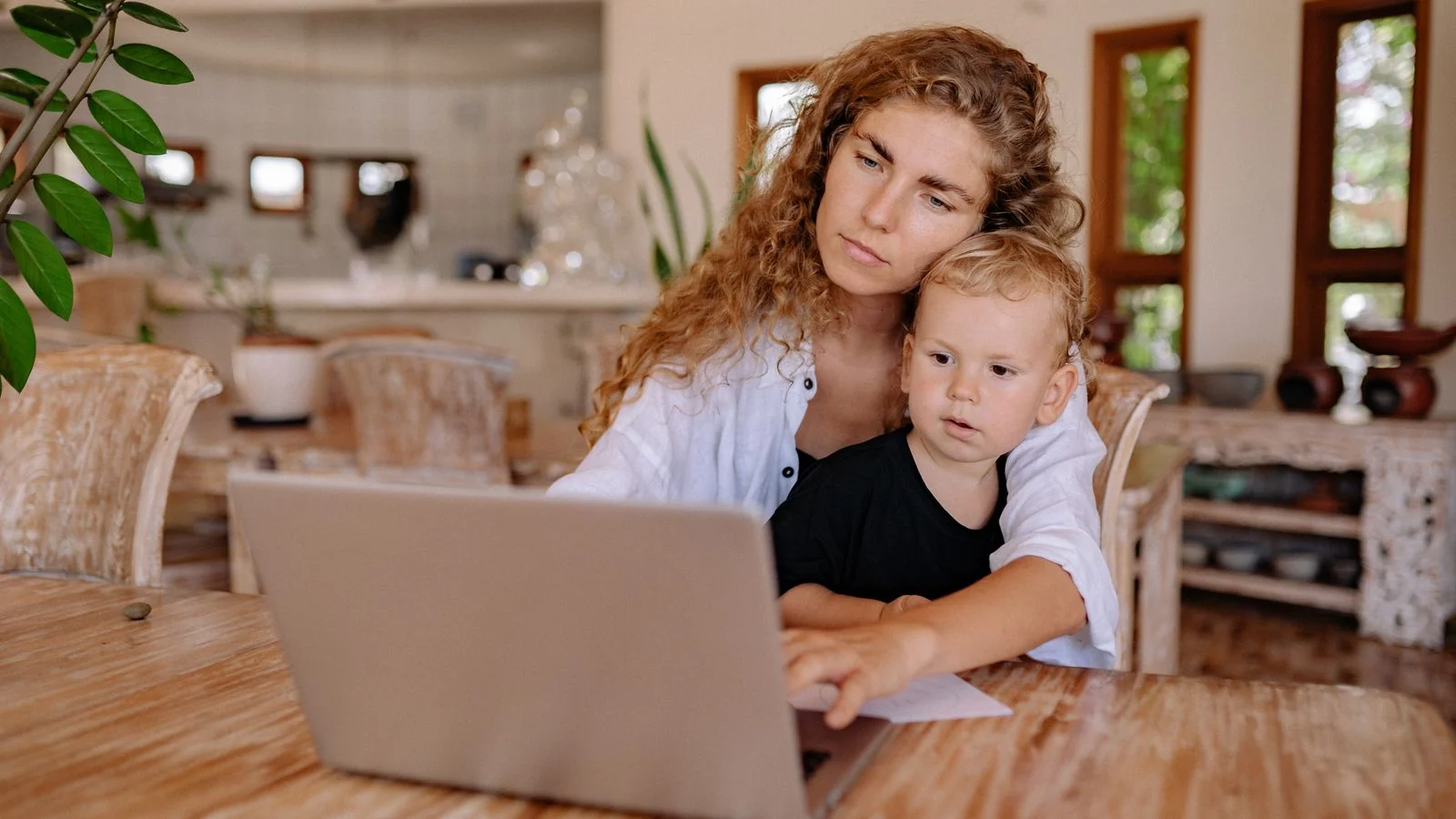 Parent and child using a laptop together at home, the audience a parenting blog is built to serve