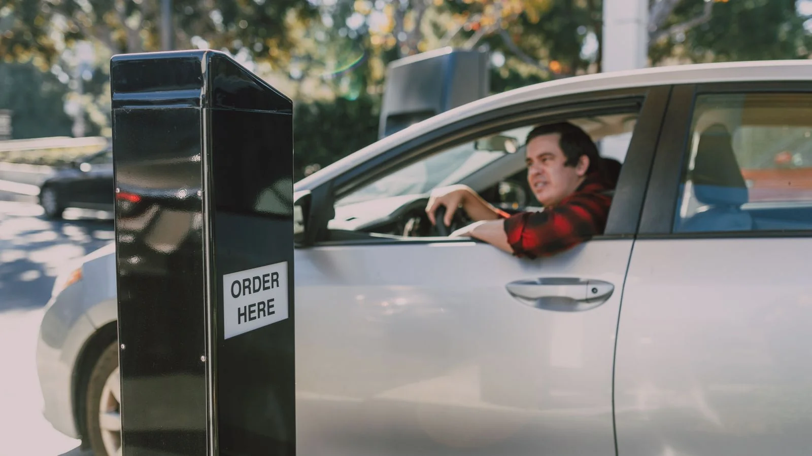 Driver ordering food at a drive-thru window, the fast-moving format restaurant trade press tracks