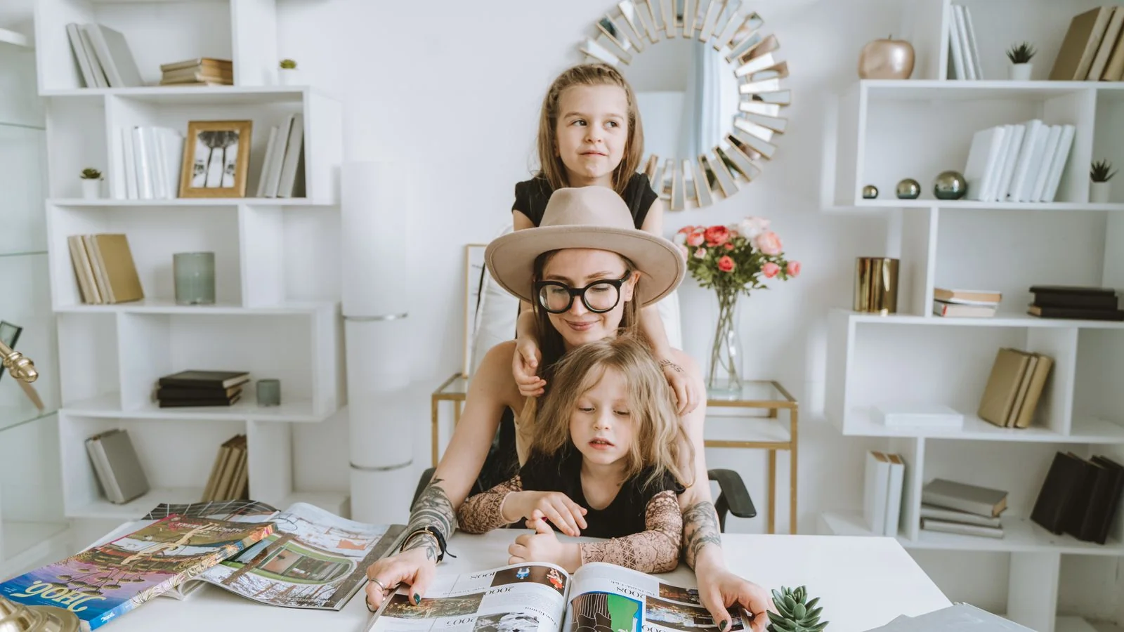 A mother and her daughters reading a magazine together at home, the practical service journalism parenting editors prize