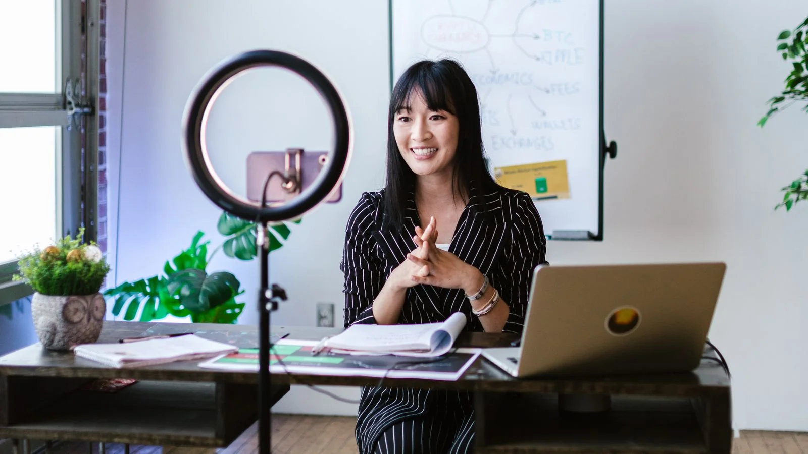 A woman recording lifestyle content with a ring light, the kind of creator energy Refinery29 covers