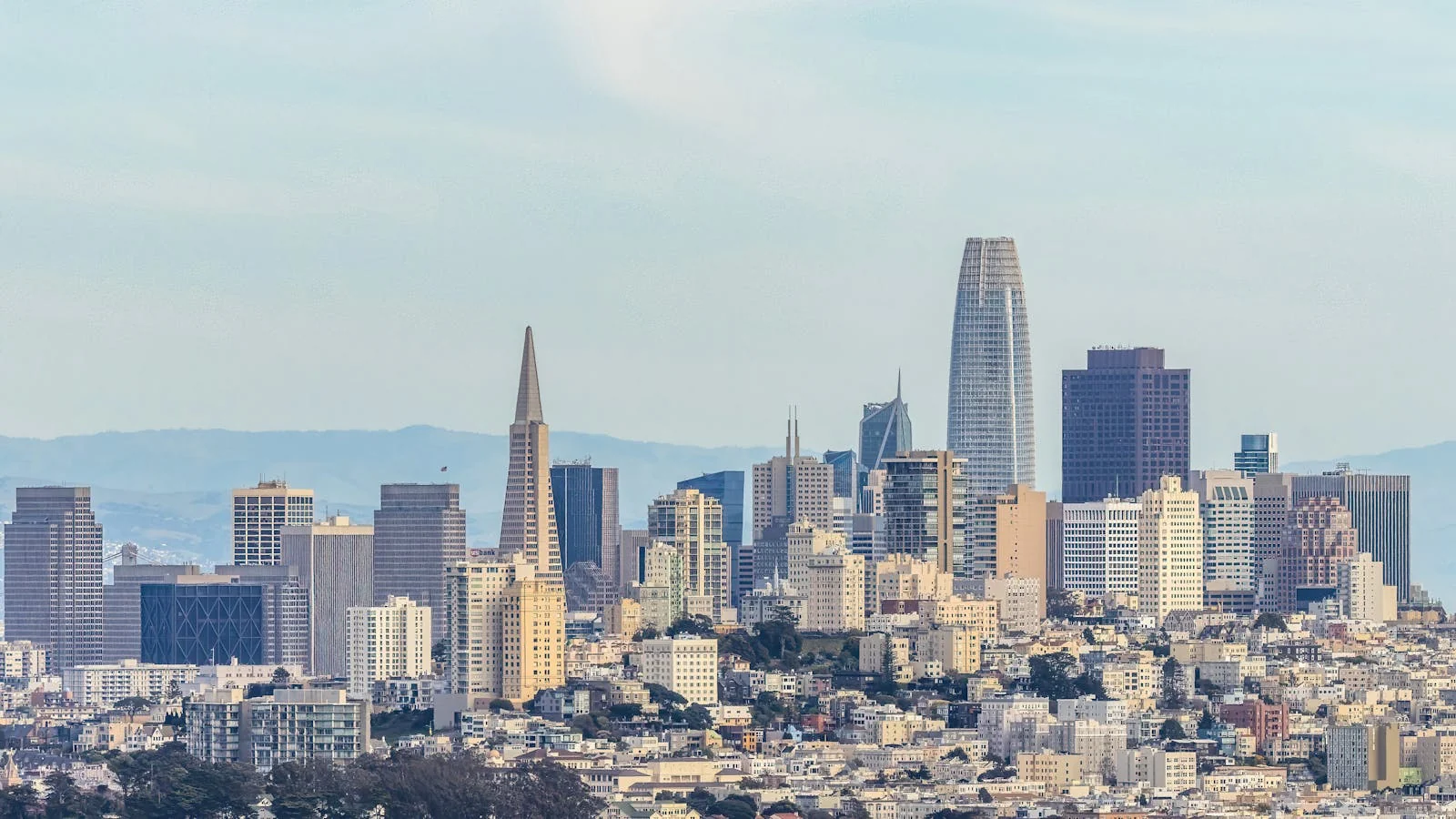 A drone view of San Francisco showing dense downtown high-rise buildings.