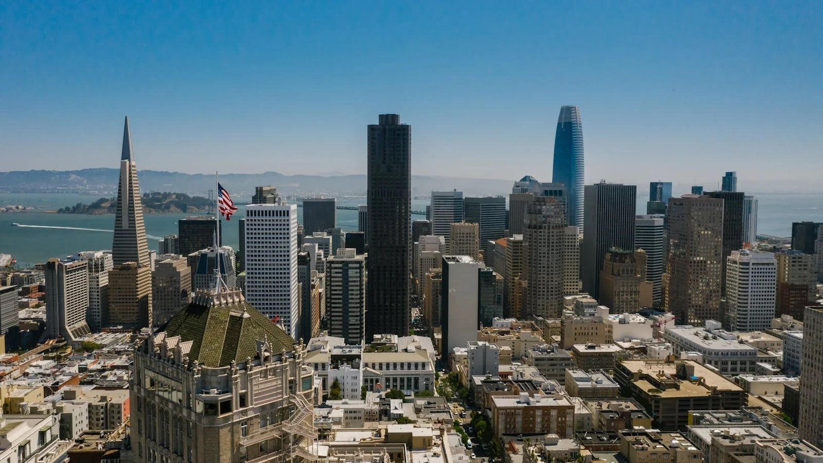 Aerial view of downtown San Francisco streets and office towers in daylight.