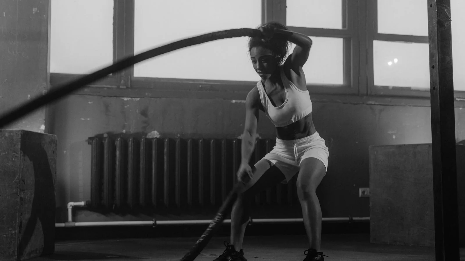 Woman working through a battle rope session, the kind of training content Shape commissions